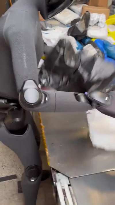 Figure 03 Robot sorting packages while Marc Benioff messes with it